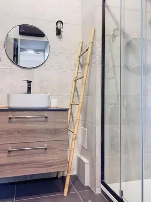 a ladder in a bathroom with a sink and a mirror at Charmant studio in Cannes