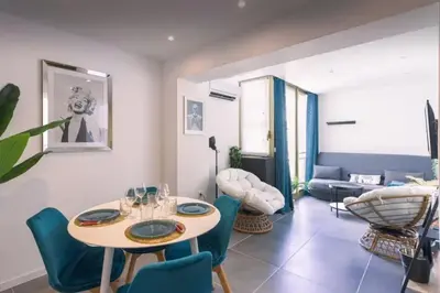 a living room with a table and chairs at appartement Carré d’or 2 pas de la croisette in Cannes