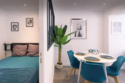 a bedroom with a bed and a table and chairs at appartement Carré d’or 2 pas de la croisette in Cannes