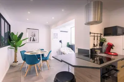 a kitchen and dining room with a table and chairs at appartement Carré d’or 2 pas de la croisette in Cannes