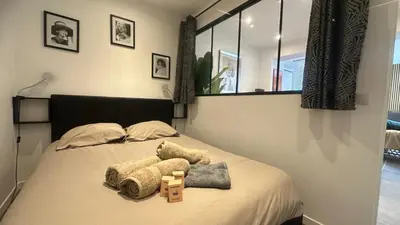 a bedroom with a bed with two towels on it at appartement Carré d’or 2 pas de la croisette in Cannes