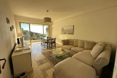 a living room with a couch and a table at WE CANNES ! Amazing Sea View 2 Bedrooms La Vista in Cannes
