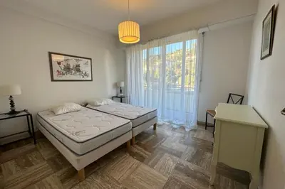 a bedroom with two beds and a large window at WE CANNES ! Amazing Sea View 2 Bedrooms La Vista in Cannes