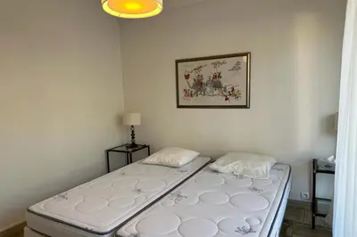 a bedroom with two beds in a room at WE CANNES ! Amazing Sea View 2 Bedrooms La Vista in Cannes