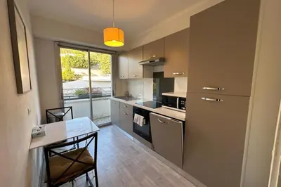 a kitchen with a table and a dining room at WE CANNES ! Amazing Sea View 2 Bedrooms La Vista in Cannes