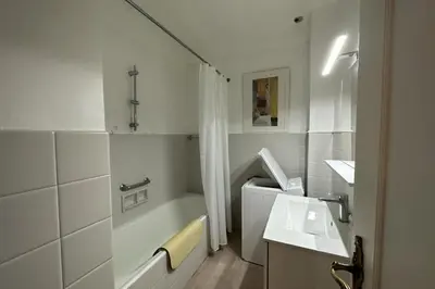 a bathroom with a sink and a bathtub and a sink at WE CANNES ! Amazing Sea View 2 Bedrooms La Vista in Cannes
