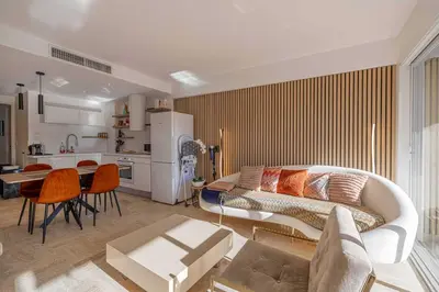 a living room with a couch and a table at Charming apartment on Boulevard Alexandre III in Cannes