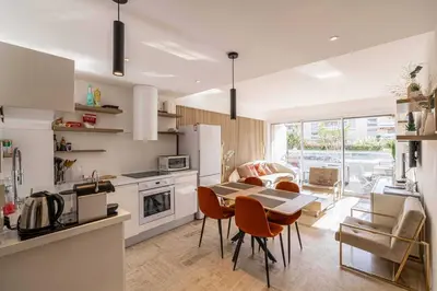 a kitchen and living room with a table and chairs at Charming apartment on Boulevard Alexandre III in Cannes