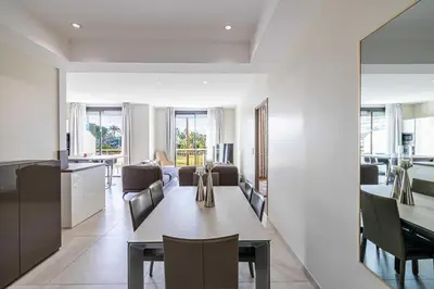 a dining room and living room with a table and chairs at Splendid apartment, Sea view, Parking - Croisette in Cannes