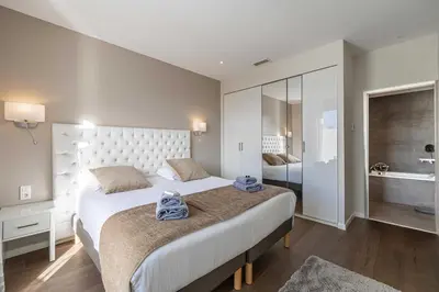 a bedroom with a large bed and a bathroom at Splendid apartment, Sea view, Parking - Croisette in Cannes