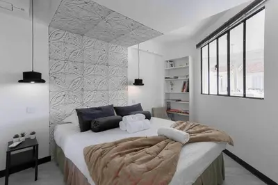 a bedroom with a large bed and a window at Cannes Bliss - 12mn à pied du Palais, 5mn plages, clim, terrasse in Cannes
