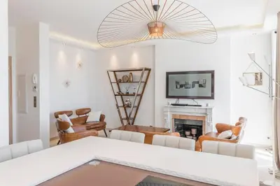 a living room with a fireplace and a chandelier at Wow this view! 2BR facing Old Port 4th floor Olam Properties in Cannes