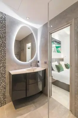 a bathroom with a sink and a bed and a mirror at Wow this view! 2BR facing Old Port 4th floor Olam Properties in Cannes