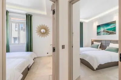 a bedroom with two beds and a mirror at Wow this view! 2BR facing Old Port 4th floor Olam Properties in Cannes