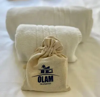 a bag of towels sitting on a bed at Wow this view! 2BR facing Old Port 4th floor Olam Properties in Cannes