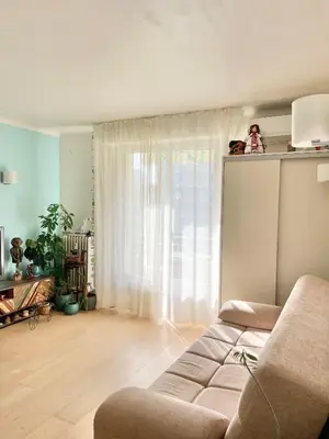 a living room with a couch and a window at Palm Beach apartment in Cannes