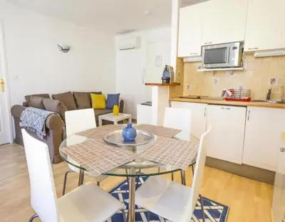 a kitchen and a table and chairs in a room at NEW Cannes Apt - Amazing Location - La Croisette in Cannes