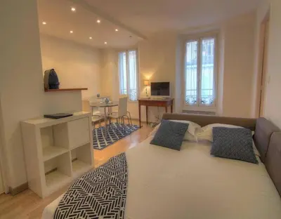 a living room with a couch and a table at NEW Cannes Apt - Amazing Location - La Croisette in Cannes