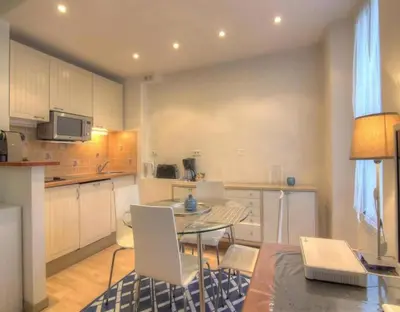 a kitchen and dining room with a table and chairs at NEW Cannes Apt - Amazing Location - La Croisette in Cannes