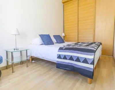a bedroom with a bed with blue pillows at NEW Cannes Apt - Amazing Location - La Croisette in Cannes