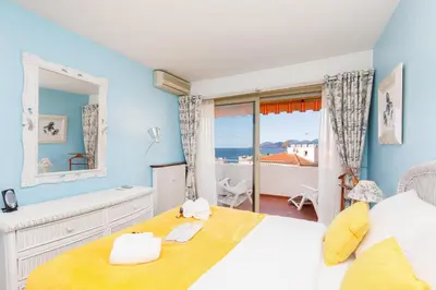 a bedroom with a bed and a large window at Gabriel YourHostHelper in Cannes