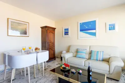 a living room with a couch and a table at Gabriel YourHostHelper in Cannes