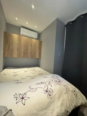 a bedroom with a bed with a flower design on it at Suite Suquet plage - 5 places in Cannes