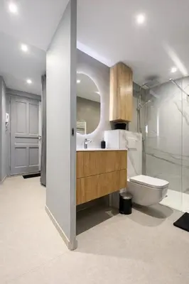 a bathroom with a toilet and a sink and a mirror at Suite Suquet plage - 5 places in Cannes
