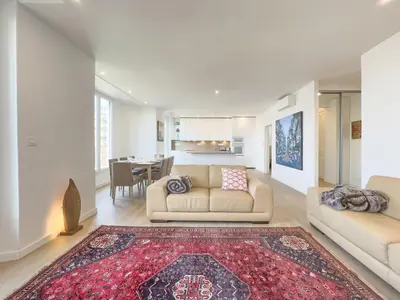 a living room with two couches and a rug at Le Duplex by Winsome Destination in Cannes