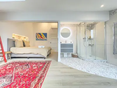 a bedroom with a bed and a glass shower at Le Duplex by Winsome Destination in Cannes