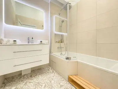 a bathroom with a tub and a sink and a shower at Le Duplex by Winsome Destination in Cannes