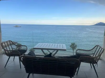 a table and chairs with a view of the ocean at Sea View Bellamare next Palais Festival in Cannes