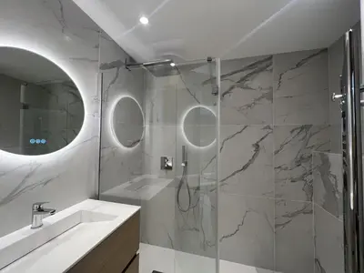 a bathroom with a shower and a sink and a mirror at Sea View Bellamare next Palais Festival in Cannes