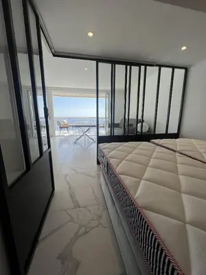 a bedroom with a bed and a view of the ocean at Sea View Bellamare next Palais Festival in Cannes