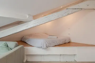 a bed in the middle of a loft at Grand Studio Cannes - 5min Plages & Gare & Palais des Festivals - Climatisation in Cannes