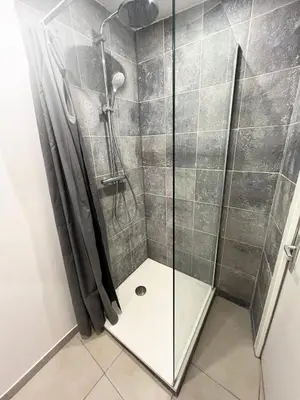 a shower with a glass door in a bathroom at Grand Studio Cannes - 5min Plages & Gare & Palais des Festivals - Climatisation in Cannes