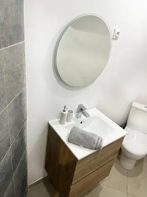 a bathroom with a sink and a mirror and a toilet at Grand Studio Cannes - 5min Plages & Gare & Palais des Festivals - Climatisation in Cannes