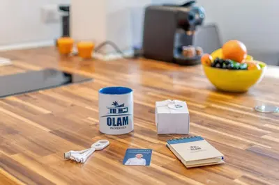 a coffee cup on a counter with a picture of a man at Cannes 3 pièces Rénové 2023 Vieux Port et Palais Olam Properties in Cannes