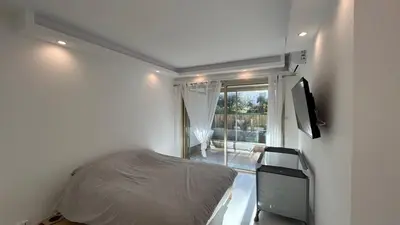 a small bedroom with a bed and a window at A010-Superbe appartement refait à neuf proche Croisette in Cannes