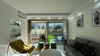 a living room with a couch and a table at A010-Superbe appartement refait à neuf proche Croisette in Cannes