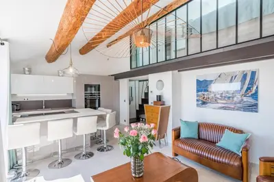 a kitchen and living room with a couch and a table at Facing old Port of Cannes Duplex WOW this view Olam Properties in Cannes