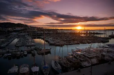 a group of boats docked in a marina at sunset at Facing old Port of Cannes Duplex WOW this view Olam Properties in Cannes