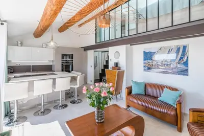 a kitchen and living room with a couch and a table at Facing old Port of Cannes Duplex WOW this view Olam Properties in Cannes