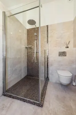 a shower with a glass door in a bathroom at Facing old Port of Cannes Duplex WOW this view Olam Properties in Cannes