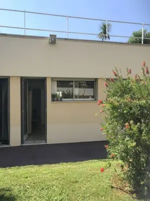 a white building with a window and a bush at Studette Pointe Croisette - Axelle Loc'Appart in Cannes