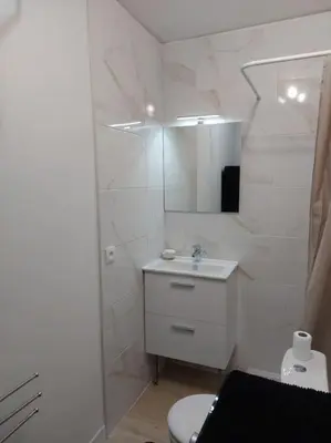 a white bathroom with a sink and a toilet at Studette Pointe Croisette - Axelle Loc'Appart in Cannes