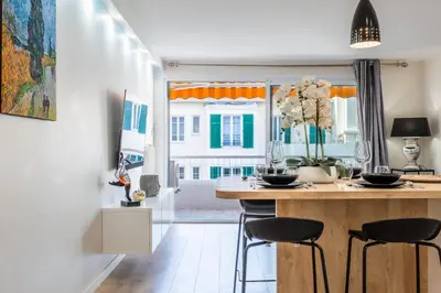 a kitchen with a table and chairs in a room at 2-room apartment with terrace close to the center in Cannes
