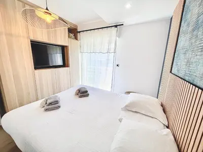 a bedroom with a bed with two shoes on it at 2 BR Croisette balcony & sea view Olam Properties in Cannes