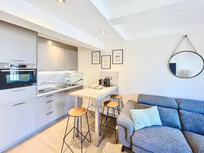 a kitchen and a living room with a couch and a table at 2 BR Croisette balcony & sea view Olam Properties in Cannes