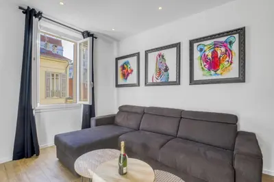 a living room with a couch and a table at 3 chambres Modern - 2 min du Palais - Climatisé - Calme in Cannes